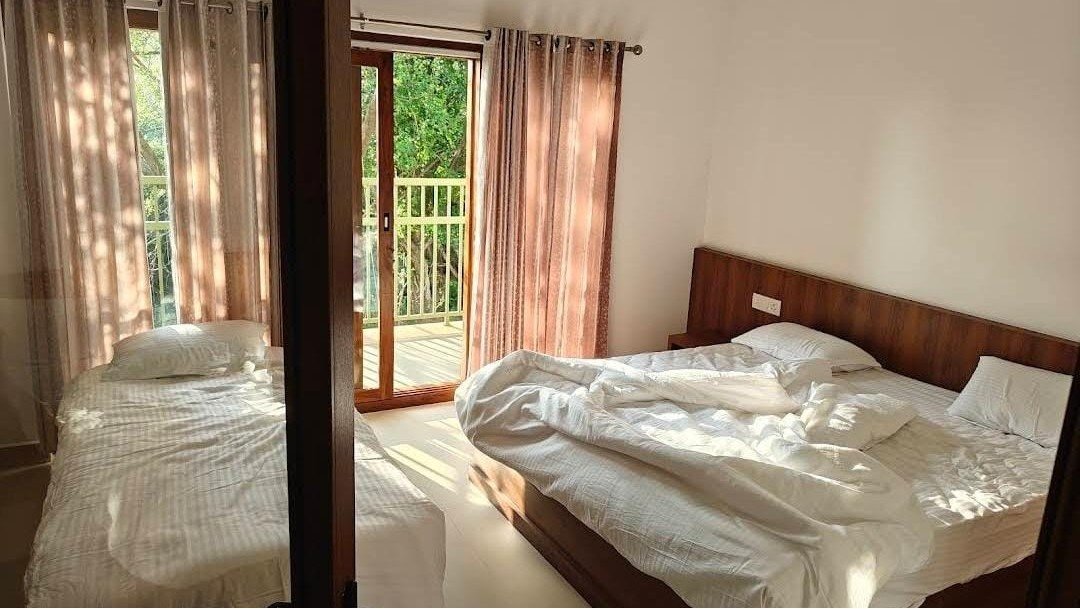 Balcony view room overlooking Seetharkundu Waterfalls at Kollengode resort