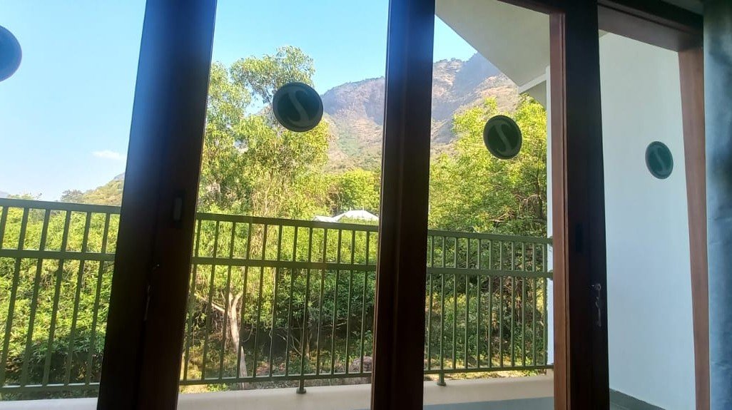 Balcony view room overlooking Seetharkundu Waterfalls at Kollengode resort